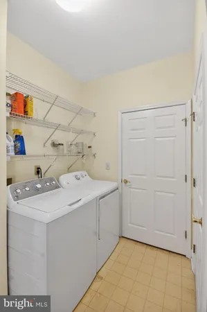 a utility room with cabinets washer and dryer