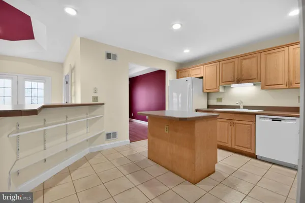 a kitchen with stainless steel appliances granite countertop a refrigerator and a stove