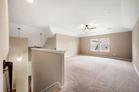 a view of a kitchen with a sink and a ceiling fan