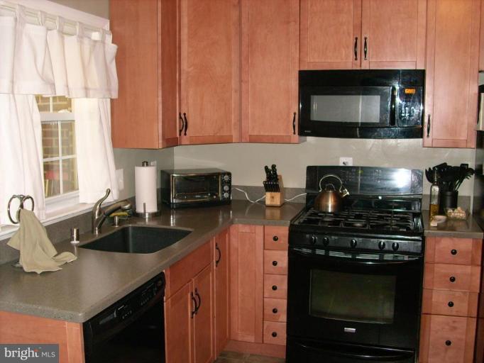 1741 Glen Ridge Road Parkville, MD 21286 - Photo 13 of 30 a kitchen with stainless steel appliances granite countertop a sink stove and microwave