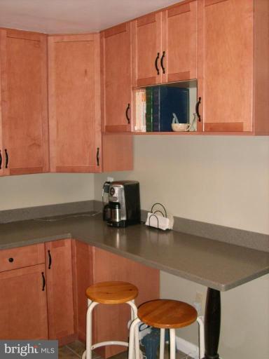 1741 Glen Ridge Road Parkville, MD 21286 - Photo 15 of 30 a kitchen with a sink cabinets and wooden floor