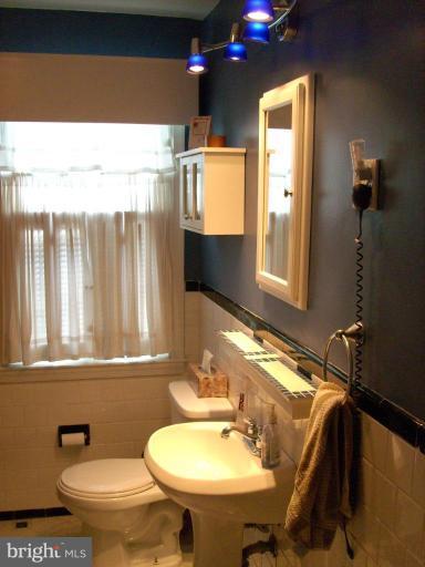 1741 Glen Ridge Road Parkville, MD 21286 - Photo 16 of 30 a bathroom with a sink a toilet and mirror