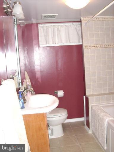 1741 Glen Ridge Road Parkville, MD 21286 - Photo 19 of 30 a bathroom with a sink a toilet and mirror