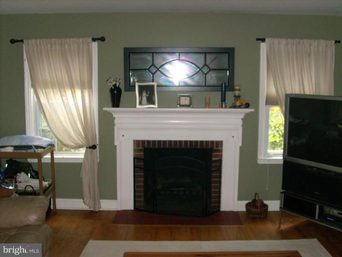1741 Glen Ridge Road Parkville, MD 21286 - Photo 7 of 30 a living room with furniture and a fireplace