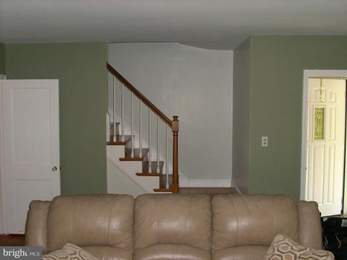 1741 Glen Ridge Road Parkville, MD 21286 - Photo 9 of 30 a living room with furniture and stairs