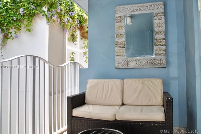 a living room with a couch and a potted plant