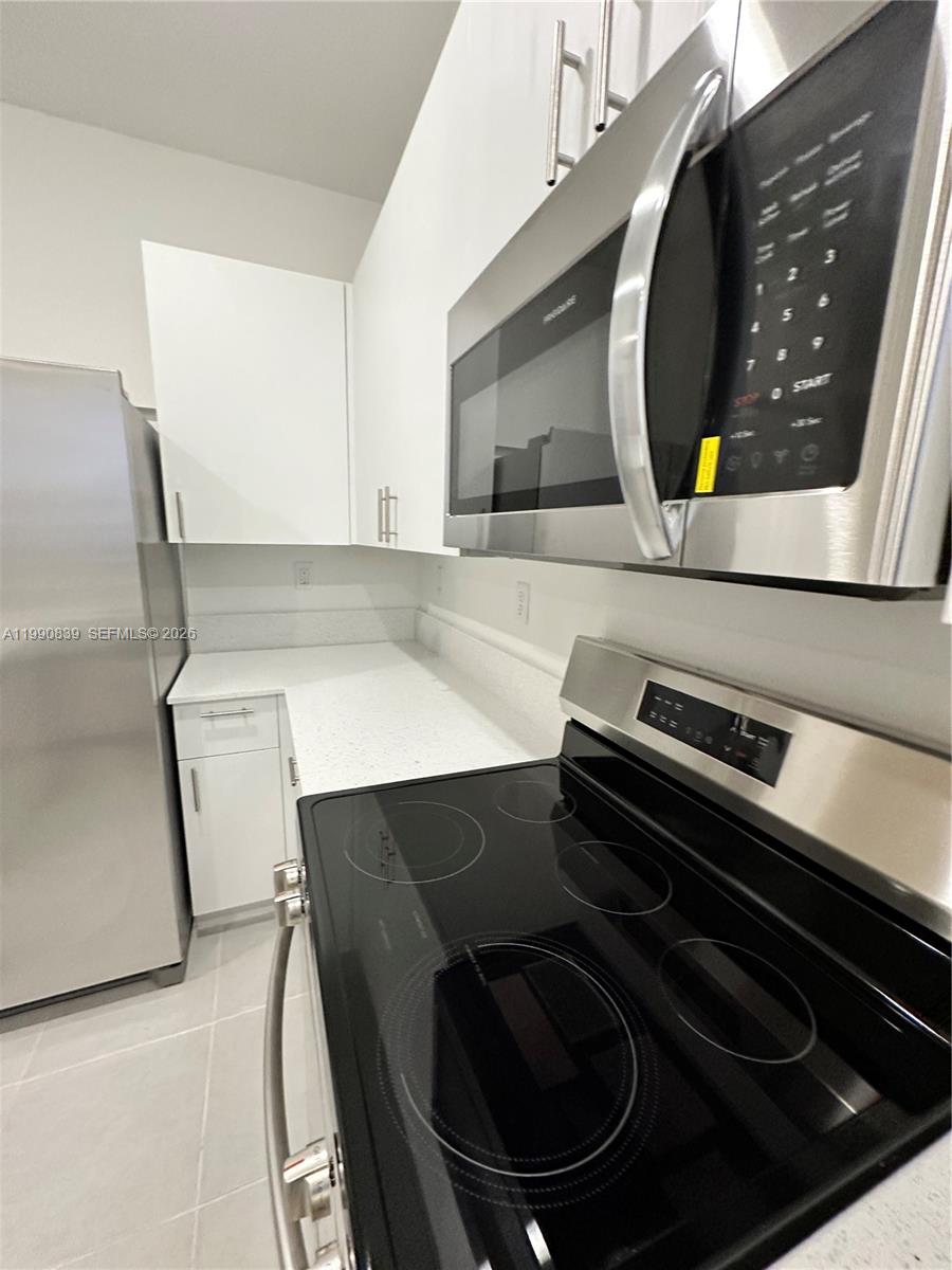 2889 Southeast 25rd, Unit 2889 Homestead, FL 33035 - Photo 3 of 23 a close view of stove and microwave