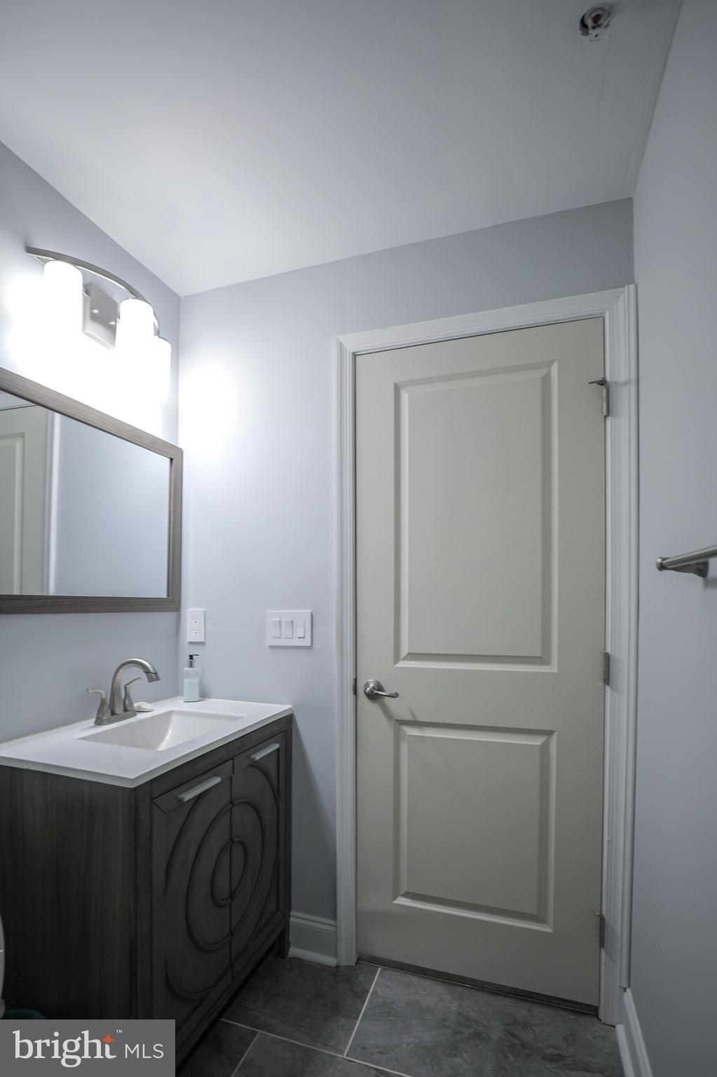 1024 Cook Drive Southeast Washington, DC 20032 - Photo 30 of 44 a bathroom with a sink and a mirror