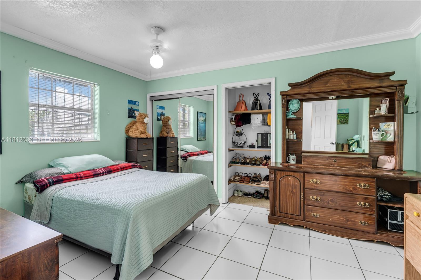 18820 Southwest 316th Street Homestead, FL 33030 - Photo 12 of 43 a bedroom with a bed and a dresser