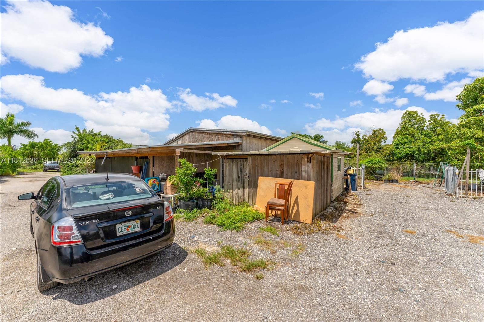 18820 Southwest 316th Street Homestead, FL 33030 - Photo 22 of 43 a front view of a house with a garden