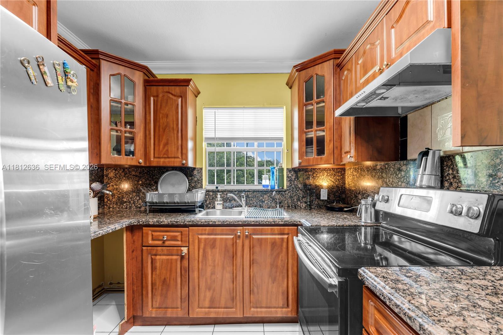 18820 Southwest 316th Street Homestead, FL 33030 - Photo 7 of 43 a kitchen with stainless steel appliances granite countertop a stove a sink and a granite counter tops
