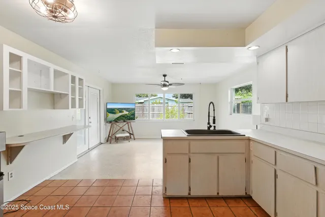 a kitchen with a sink a stove cabinets and counter space