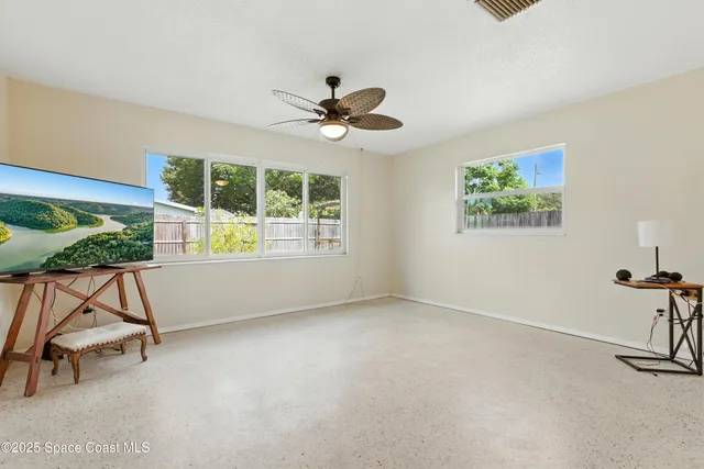 a view of room with a window and a ceiling fan