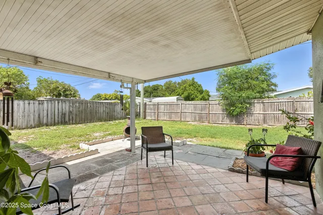 a view of a yard with furniture and outdoor seating