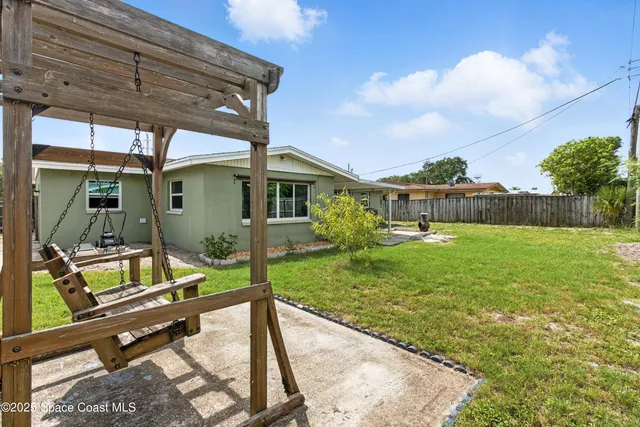 a view of backyard with hardwood and a patio