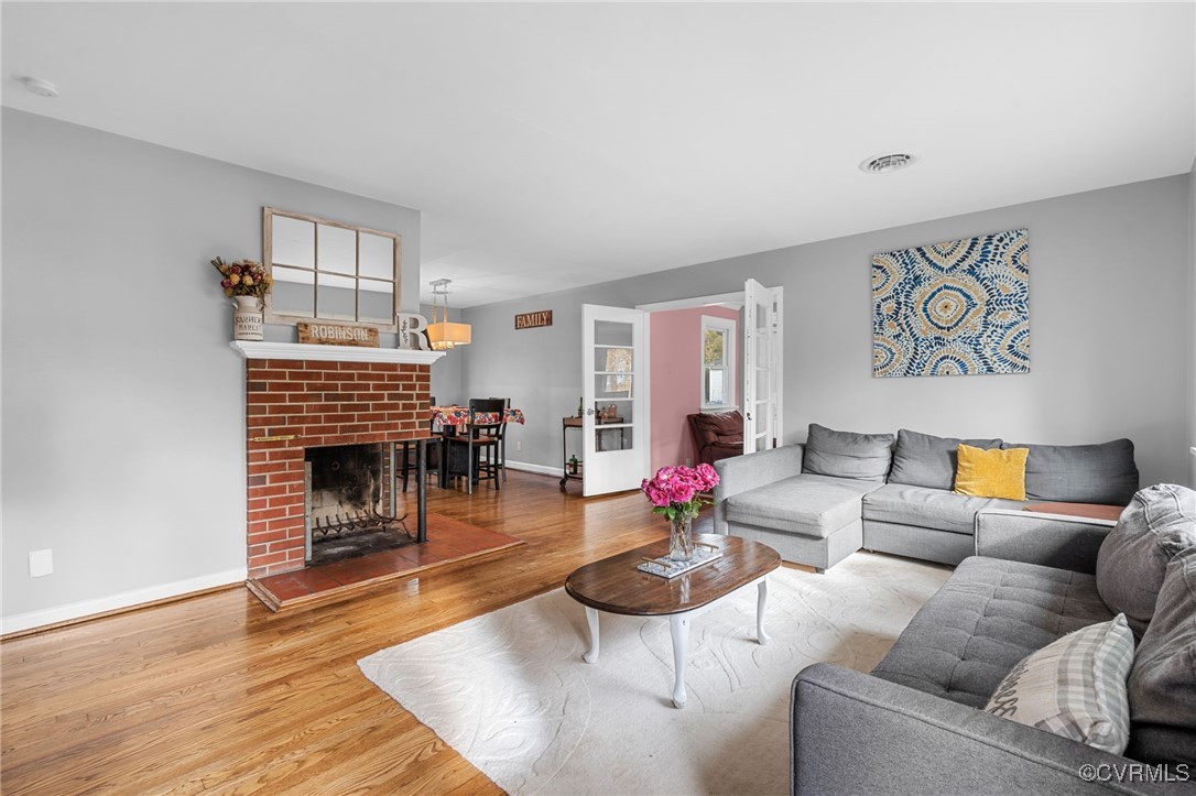 2308 Adelphi Road Henrico, VA 23229 - Photo 3 of 19 Living room with a brick fireplace and hardwood /