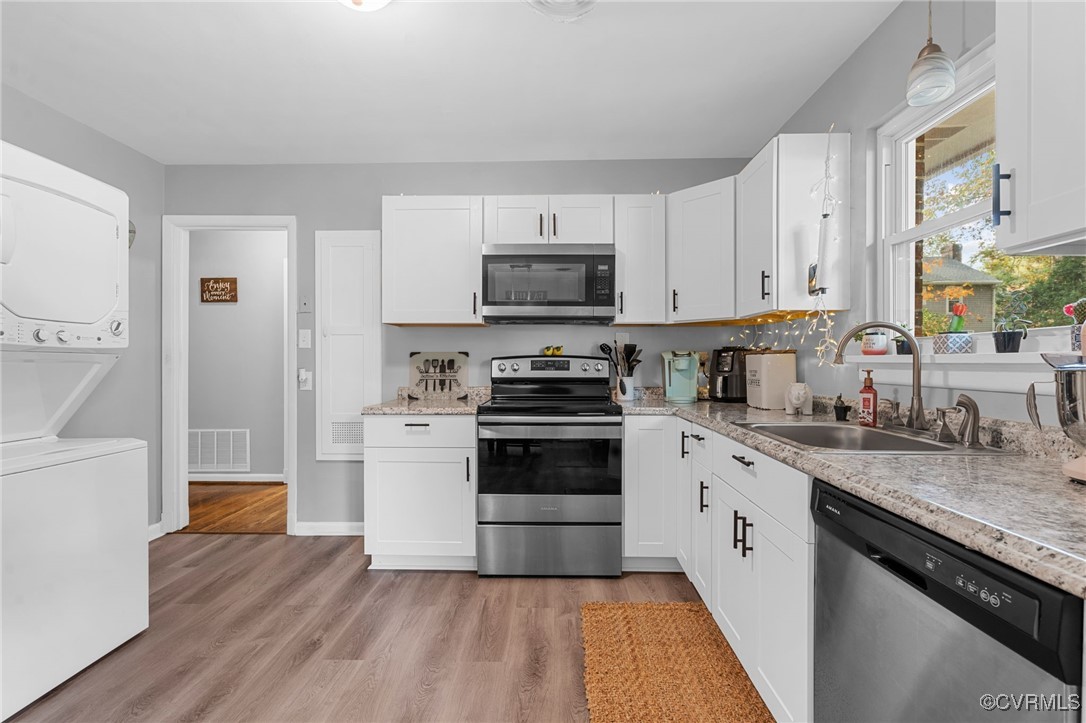 2308 Adelphi Road Henrico, VA 23229 - Photo 5 of 19 Kitchen featuring white cabinetry, sink, stacked w