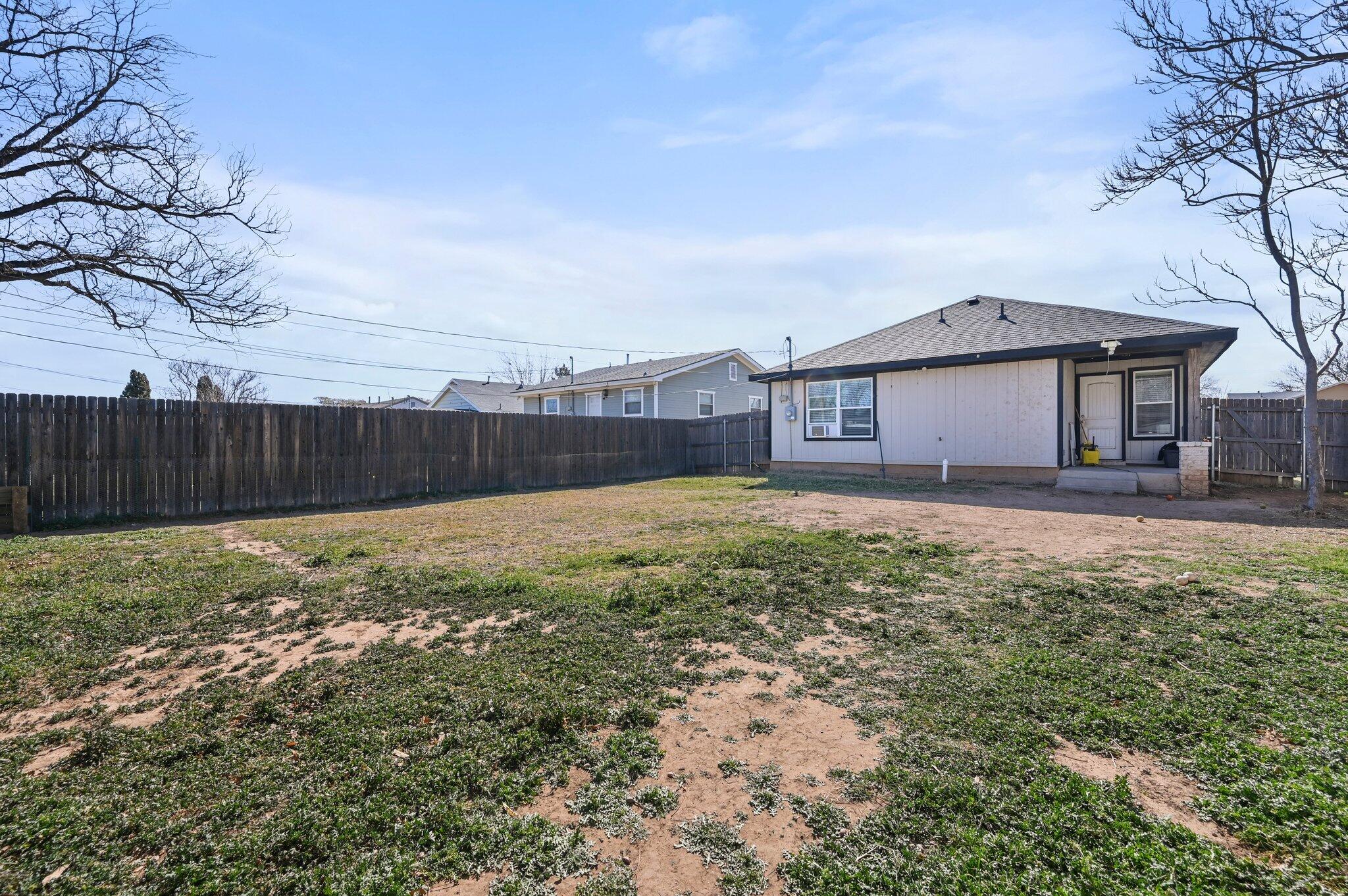 2116 24th Street, Unit 1 Lubbock, TX 79411 - Photo 12 of 13 a view of a house with a yard