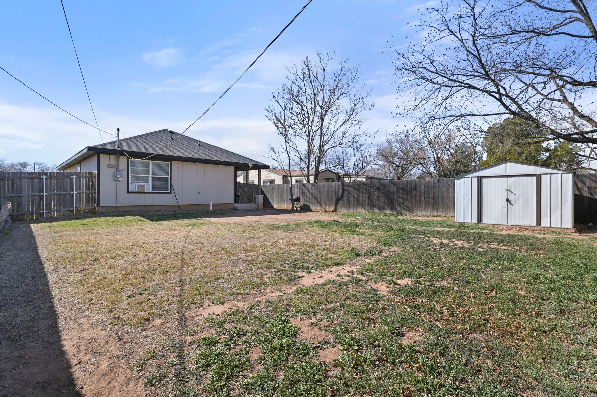 2116 24th Street, Unit 1 Lubbock, TX 79411 - Photo 13 of 13 a front view of house with a garden
