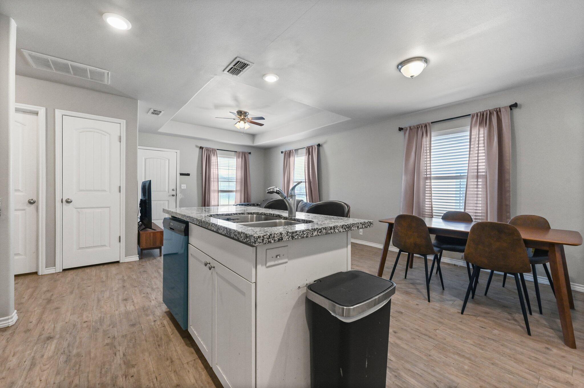 2116 24th Street, Unit 1 Lubbock, TX 79411 - Photo 5 of 13 a kitchen with a table and chairs in it