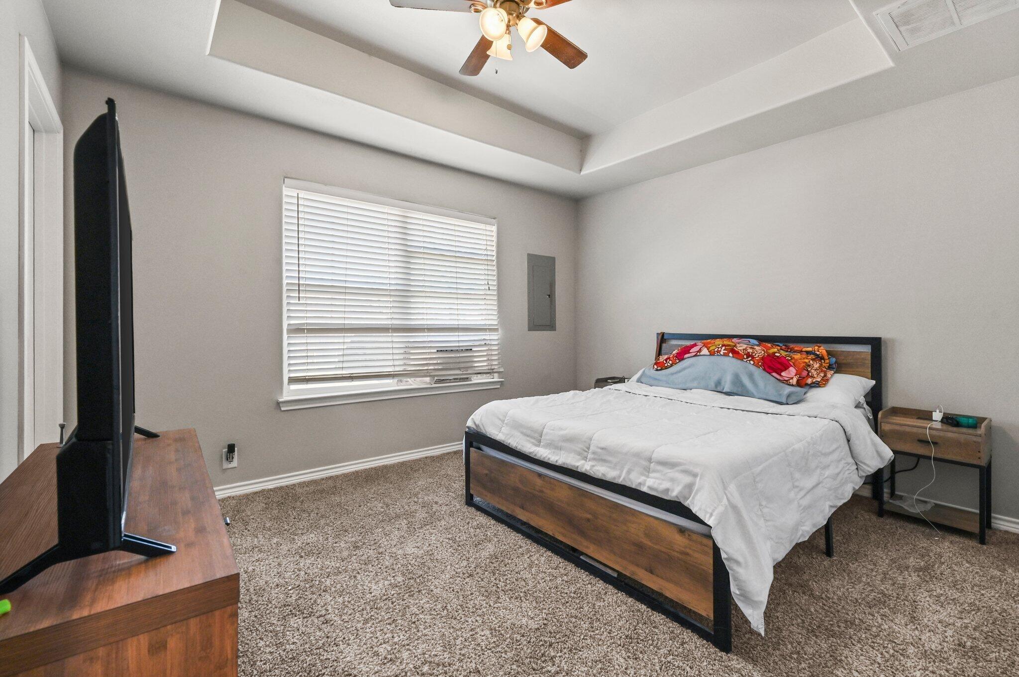 2116 24th Street, Unit 1 Lubbock, TX 79411 - Photo 6 of 13 a bedroom with a bed and a window