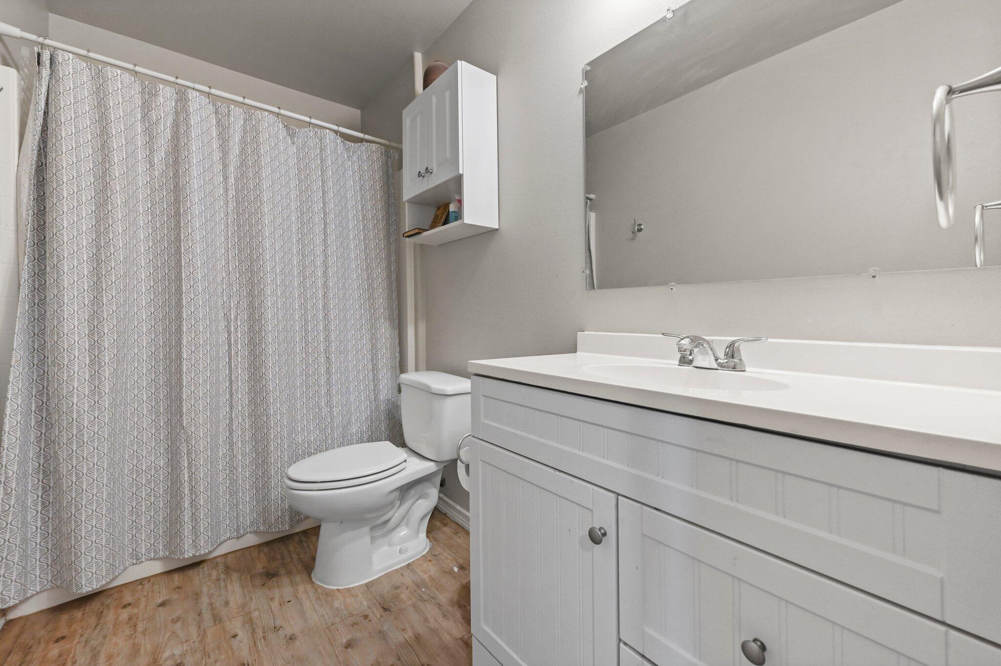 2116 24th Street, Unit 1 Lubbock, TX 79411 - Photo 10 of 13 a bathroom with a sink toilet and shower