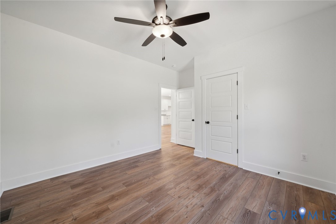 Lot 1 Oak Hill Road Cumberland, VA 23040 - Photo 14 of 26 an empty room with wooden floor ceiling fan and window
