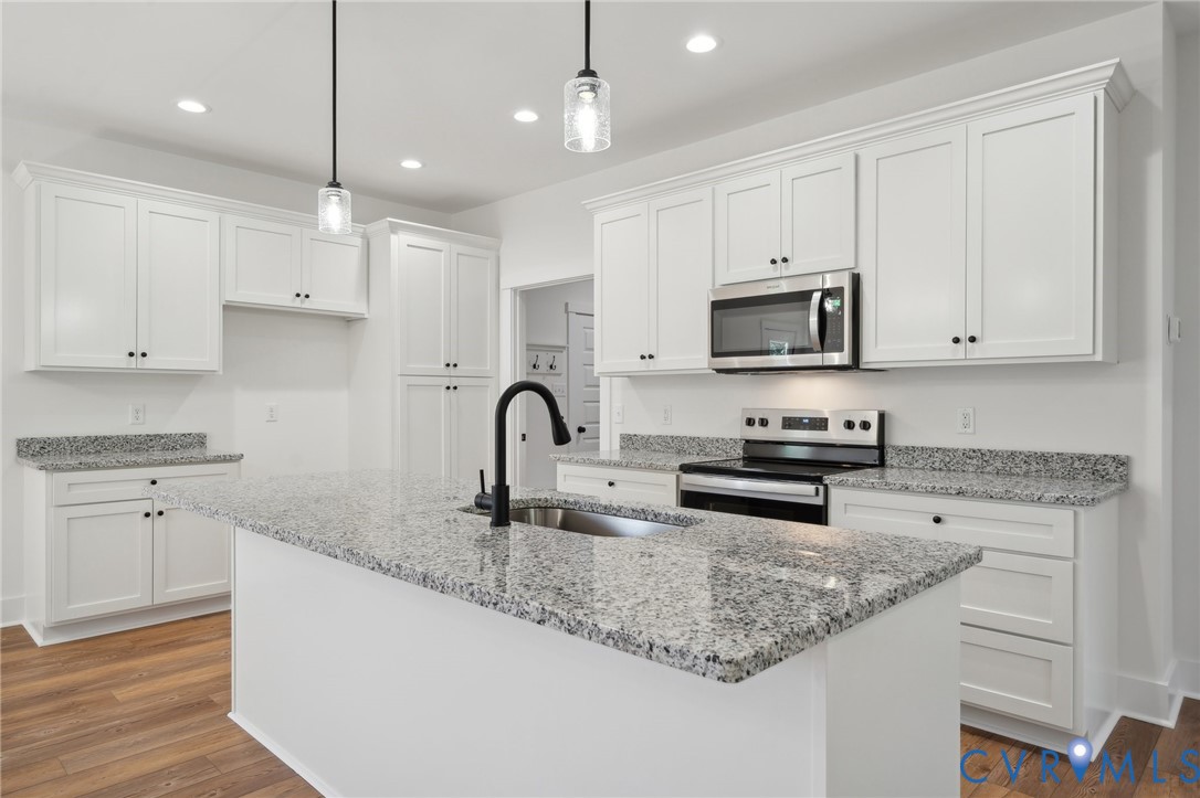 Lot 1 Oak Hill Road Cumberland, VA 23040 - Photo 9 of 26 a kitchen with kitchen island granite countertop white cabinets white stainless steel appliances and a sink