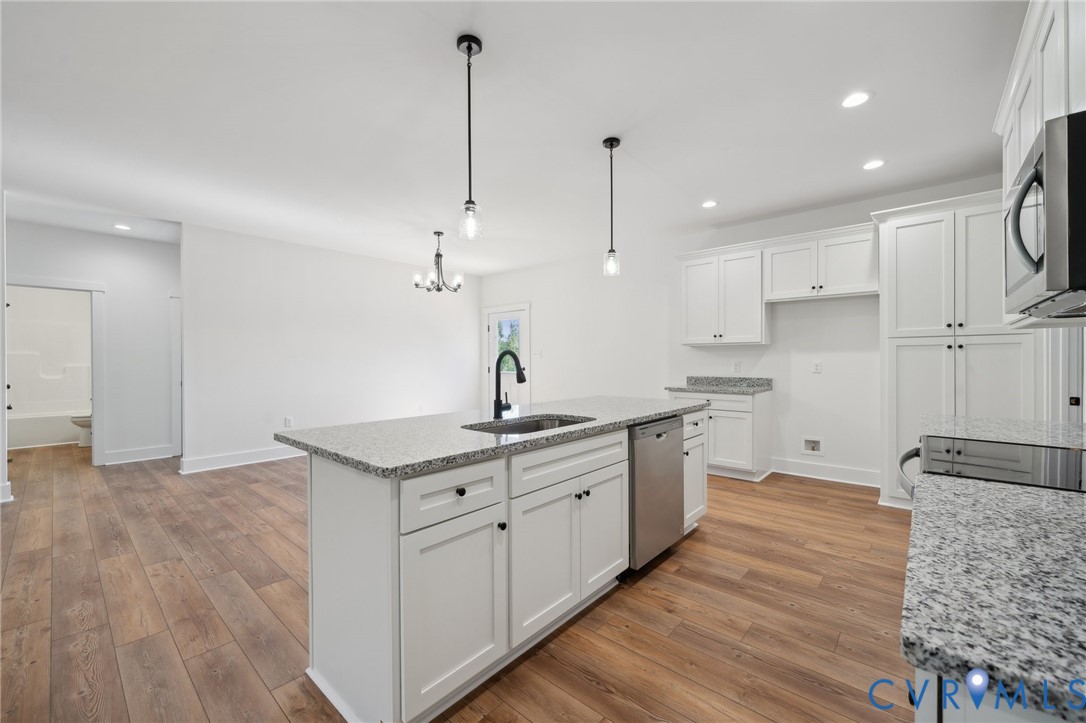 Lot 1 Oak Hill Road Cumberland, VA 23040 - Photo 10 of 26 a kitchen with stainless steel appliances granite countertop a sink a stove a refrigerator and white cabinets with wooden floor