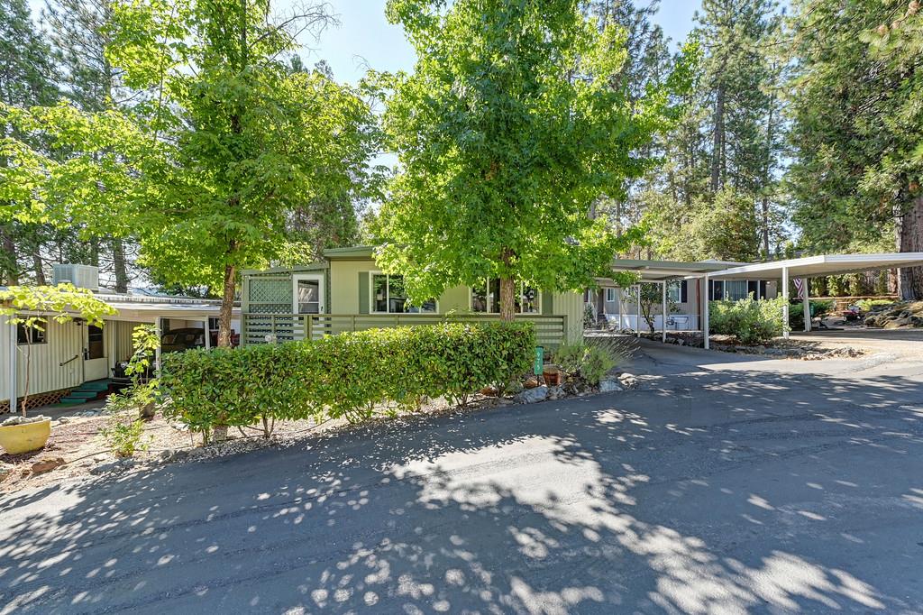 975 Amber Loop Grass Valley, CA 95945 - Photo 3 of 44 a front view of a house with a yard and a garden