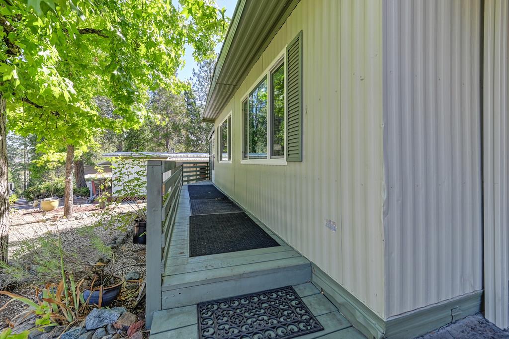 975 Amber Loop Grass Valley, CA 95945 - Photo 7 of 44 a view of balcony with wooden floor and fence