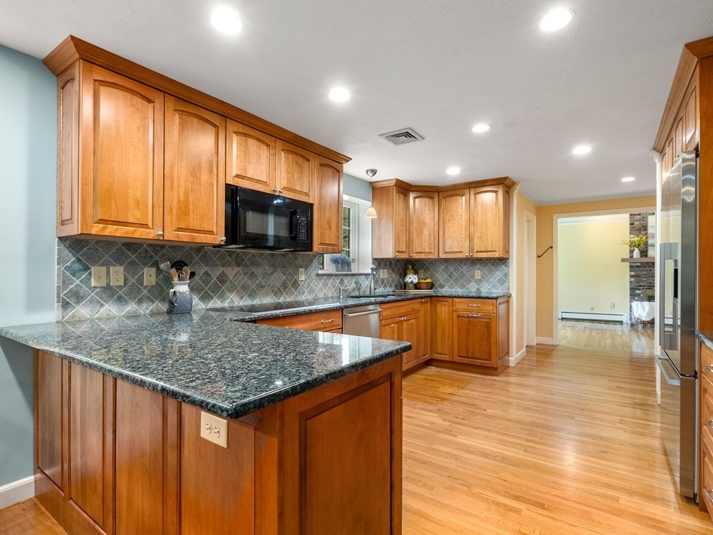 123 Victoria Road Sudbury, MA 01776 - Photo 11 of 42 a kitchen with stainless steel appliances granite countertop wooden cabinets a sink and a granite counter tops