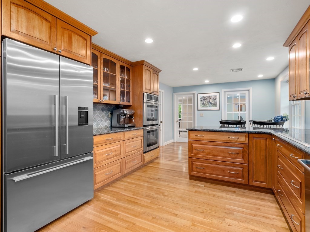 123 Victoria Road Sudbury, MA 01776 - Photo 14 of 42 a kitchen with stainless steel appliances granite countertop a refrigerator and a stove top oven