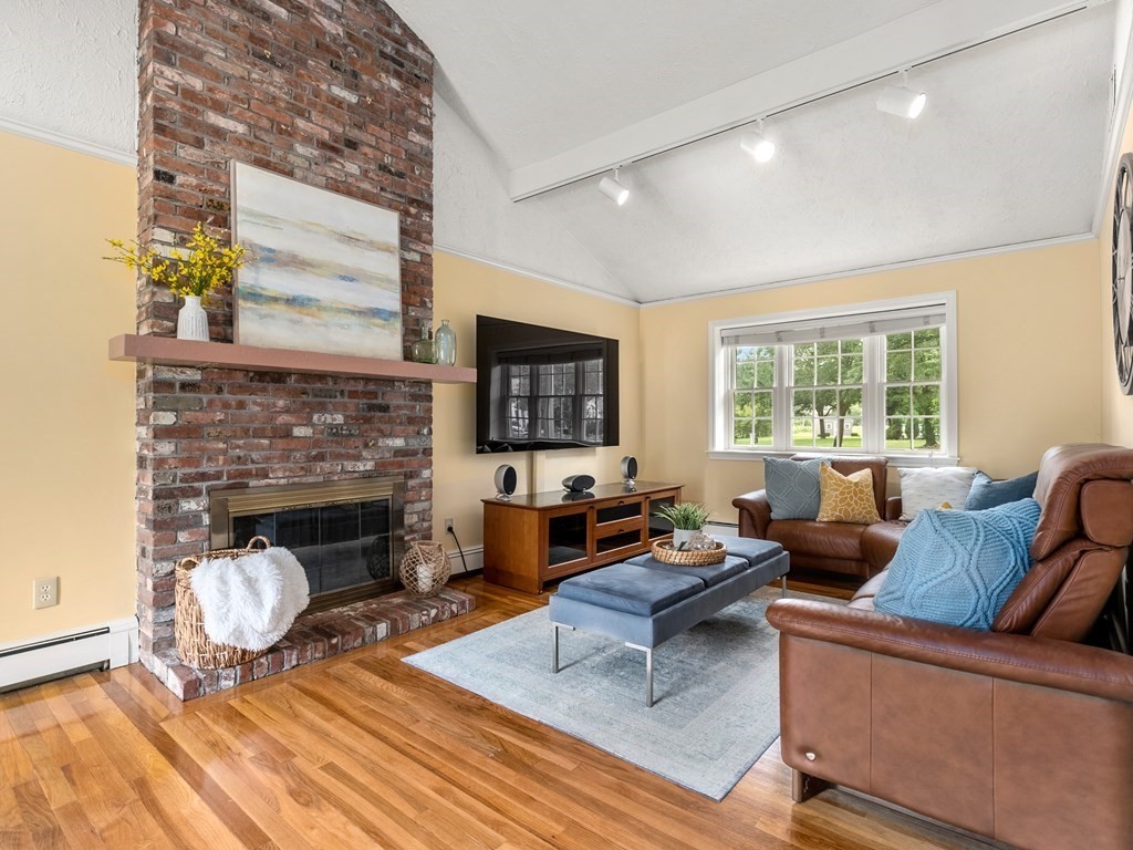 123 Victoria Road Sudbury, MA 01776 - Photo 19 of 42 a living room with furniture a fireplace and a flat screen tv