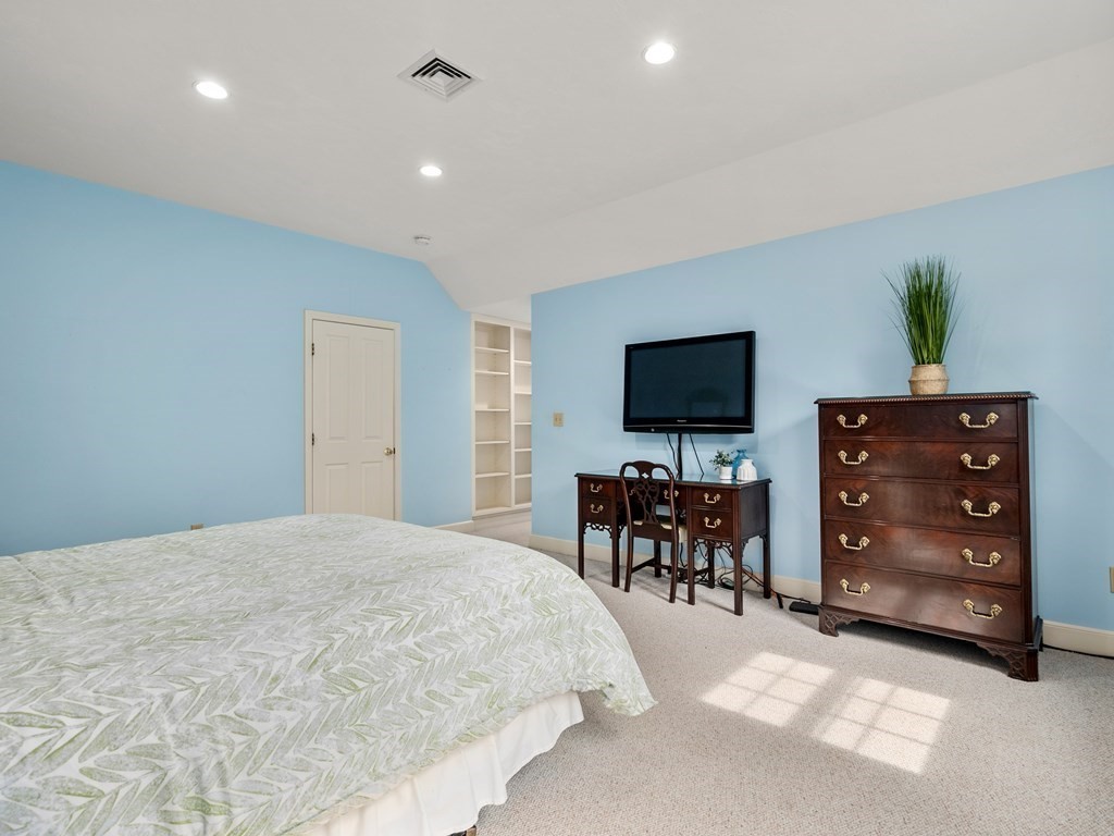 123 Victoria Road Sudbury, MA 01776 - Photo 23 of 42 a spacious bedroom with a bed and a flat screen tv