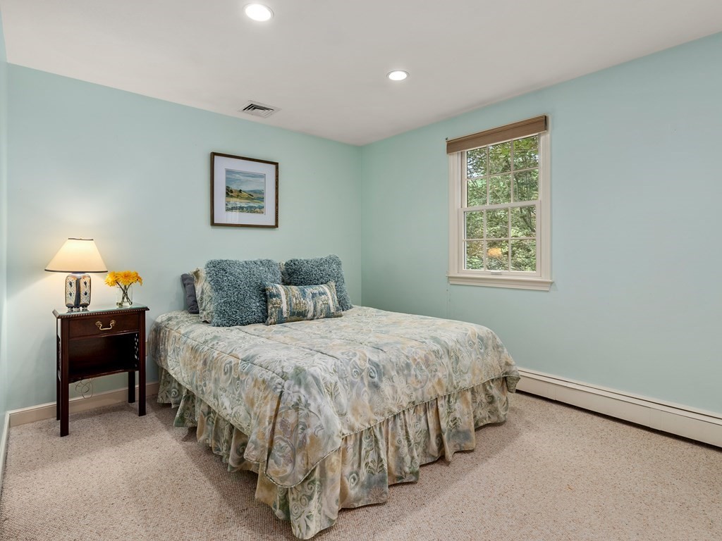 123 Victoria Road Sudbury, MA 01776 - Photo 27 of 42 a bedroom with a bed and a lamp