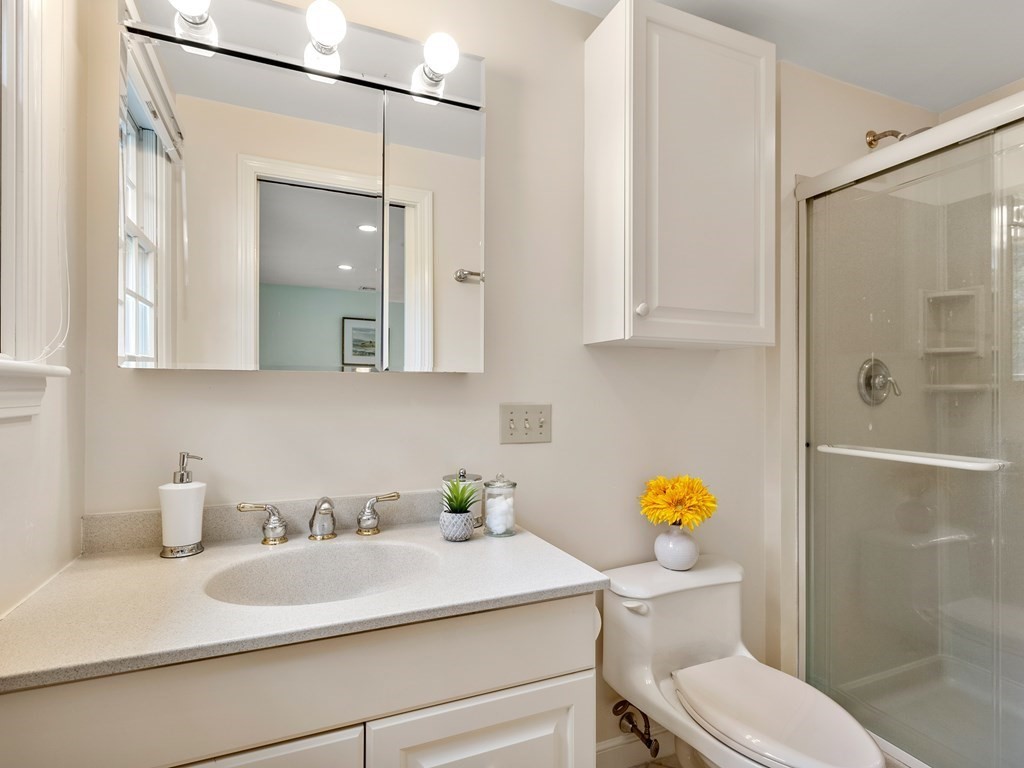 123 Victoria Road Sudbury, MA 01776 - Photo 28 of 42 a bathroom with a granite countertop sink a toilet and shower