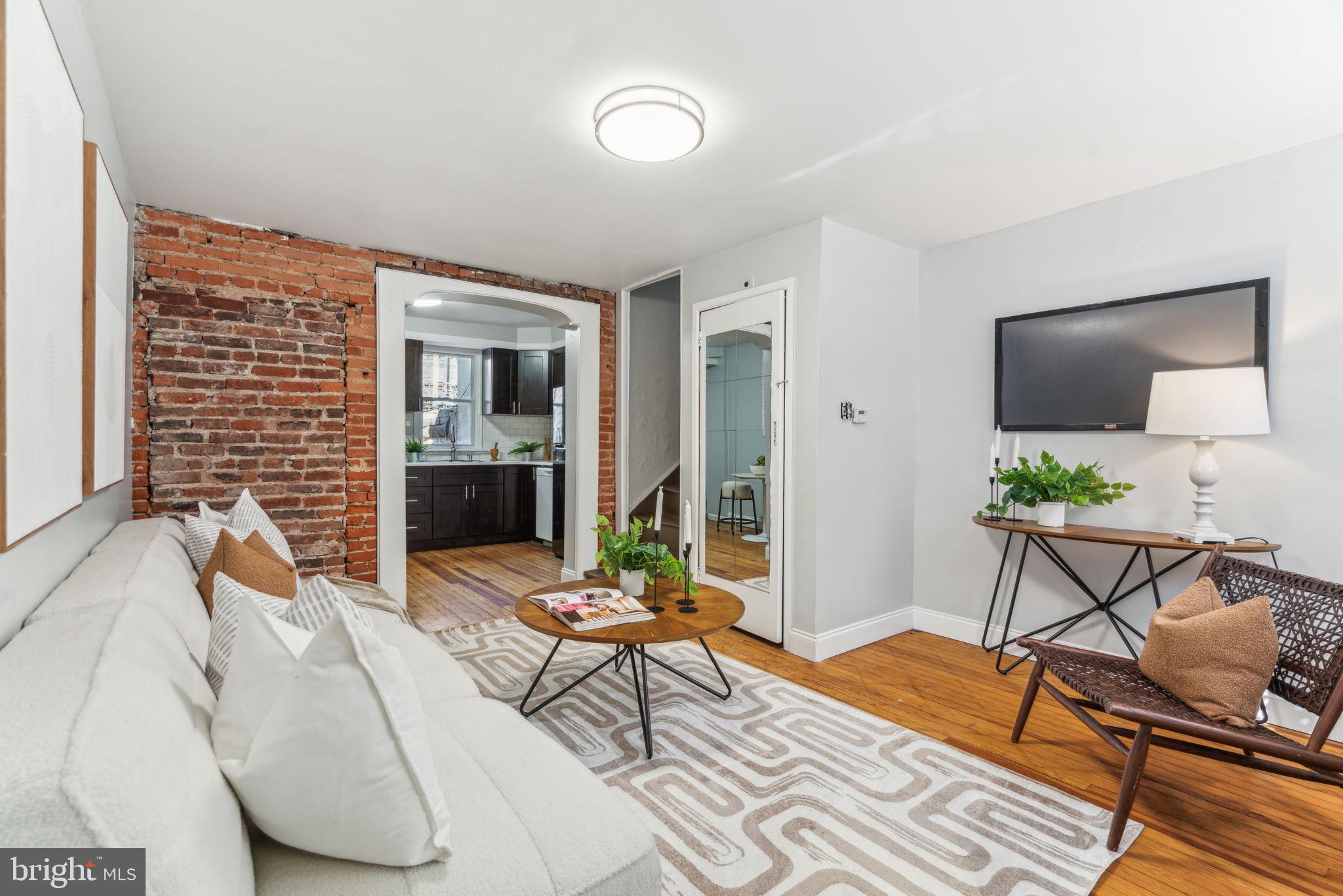 1314 South Warnock Street Philadelphia, PA 19147 - Photo 1 of 24 a living room with furniture and a flat screen tv