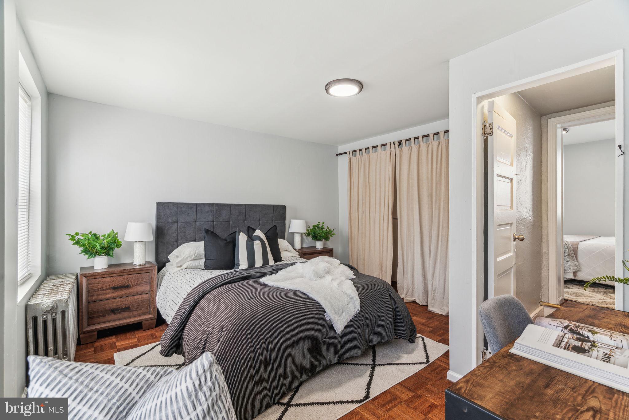 1314 South Warnock Street Philadelphia, PA 19147 - Photo 14 of 24 a bedroom with a bed and wooden floor