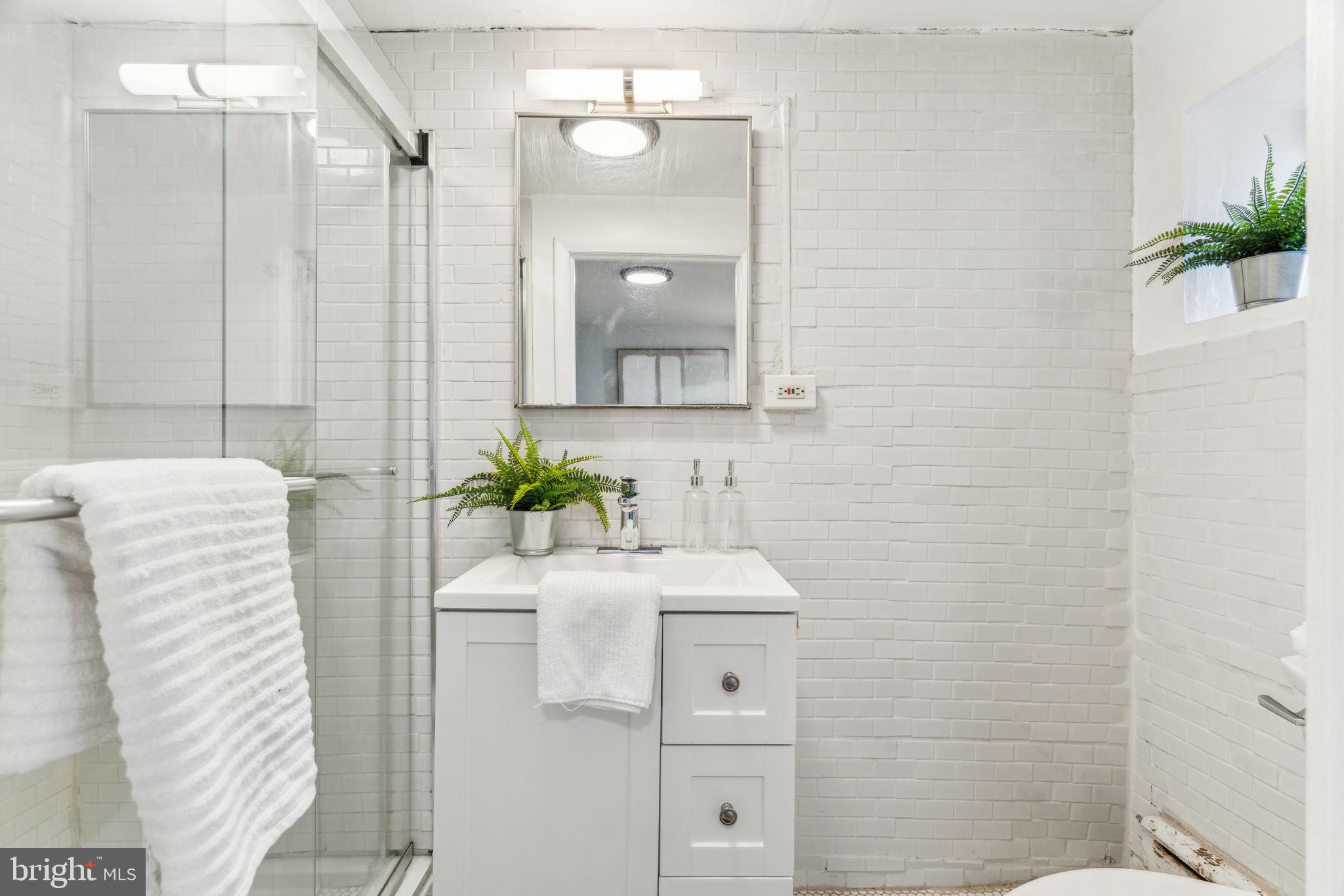 1314 South Warnock Street Philadelphia, PA 19147 - Photo 18 of 24 a bathroom with a sink a toilet and shower