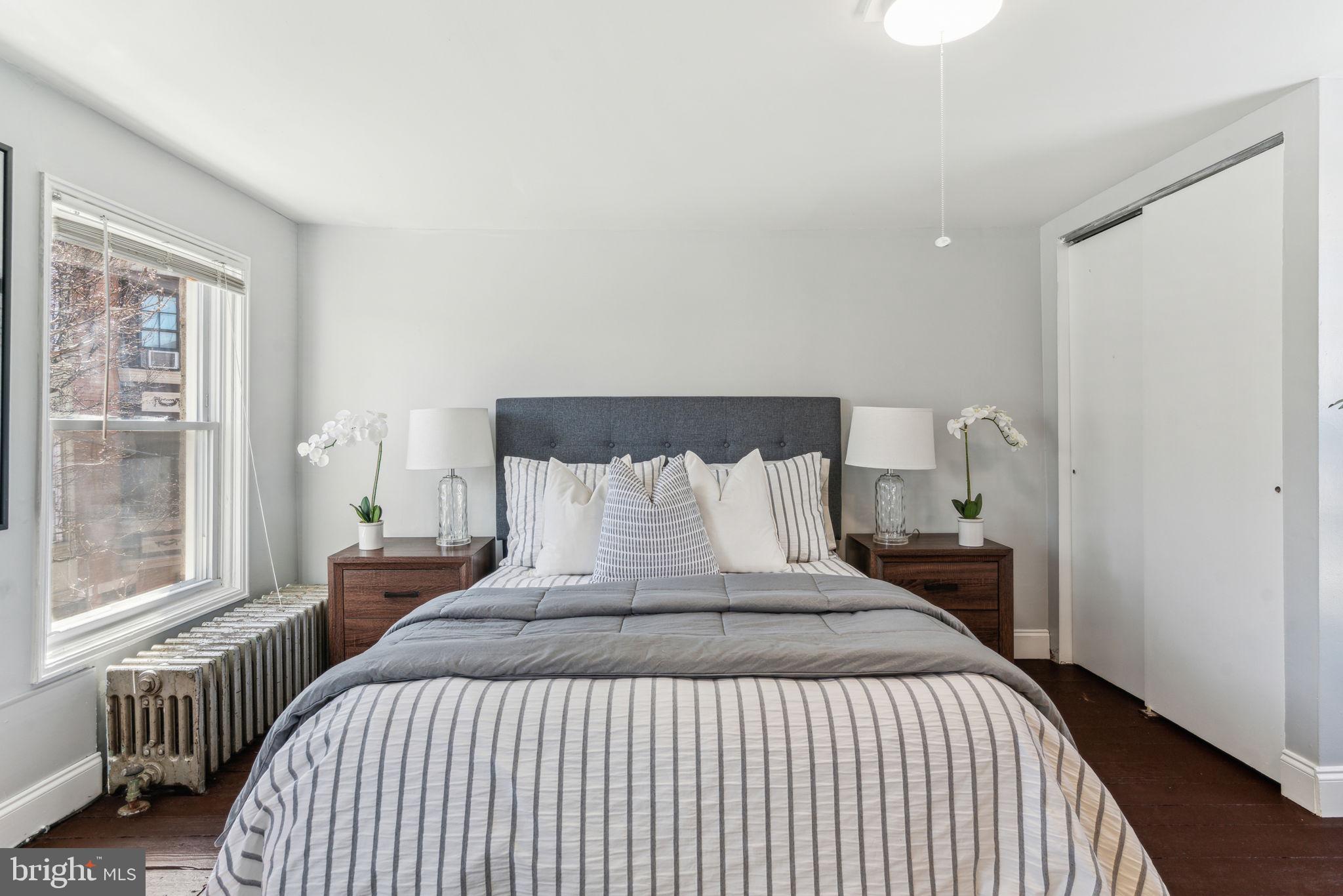 1314 South Warnock Street Philadelphia, PA 19147 - Photo 22 of 24 a bedroom with a bed and wooden floor