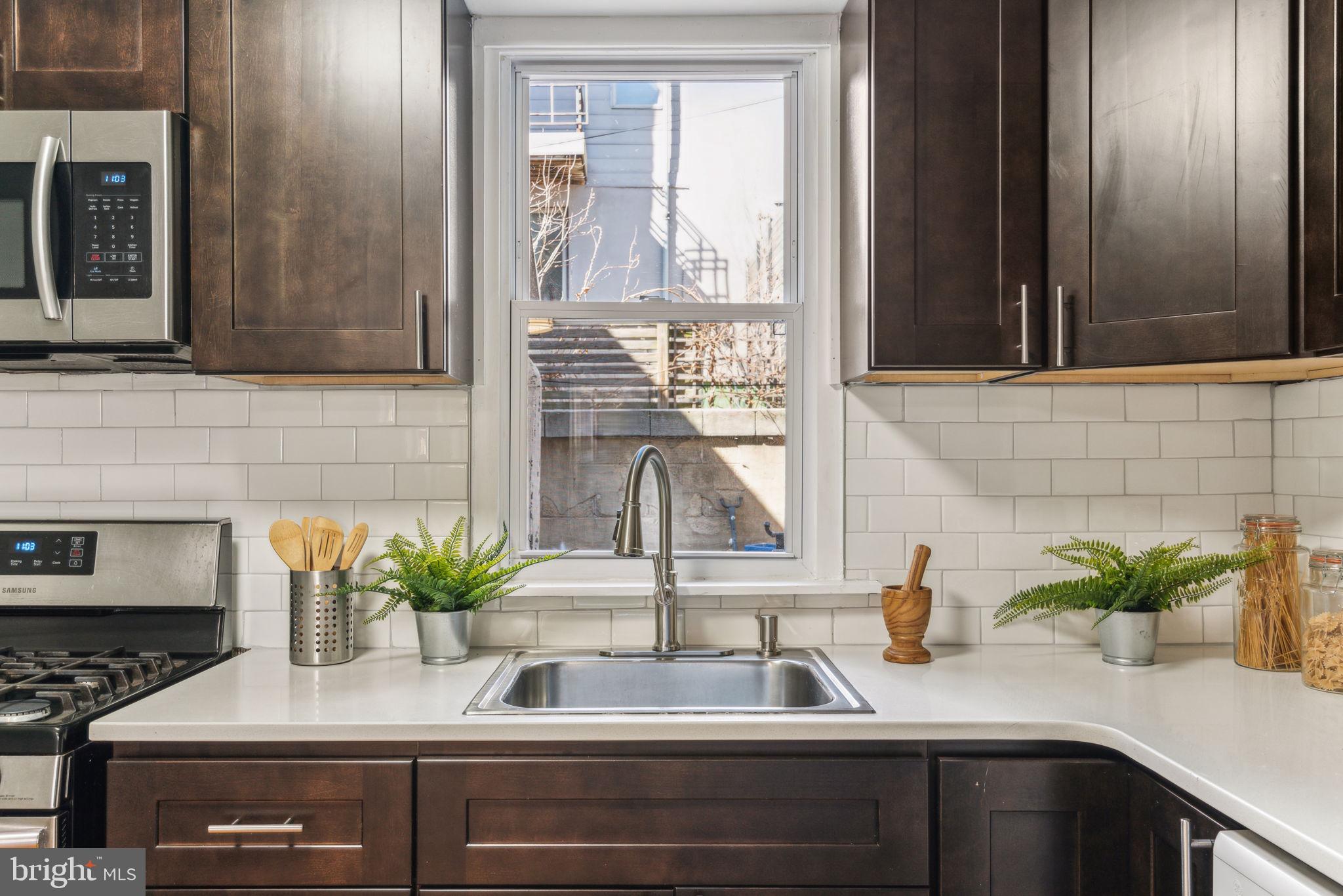 1314 South Warnock Street Philadelphia, PA 19147 - Photo 8 of 24 a kitchen with a sink and a potted plant