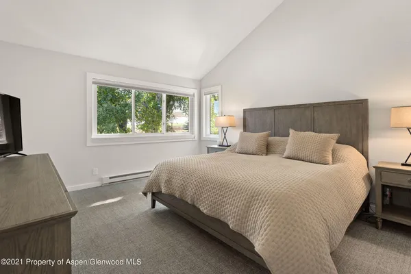 a bed room with a bed and a television