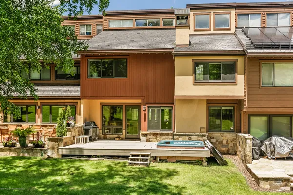 a view of a house with a yard patio and swimming pool