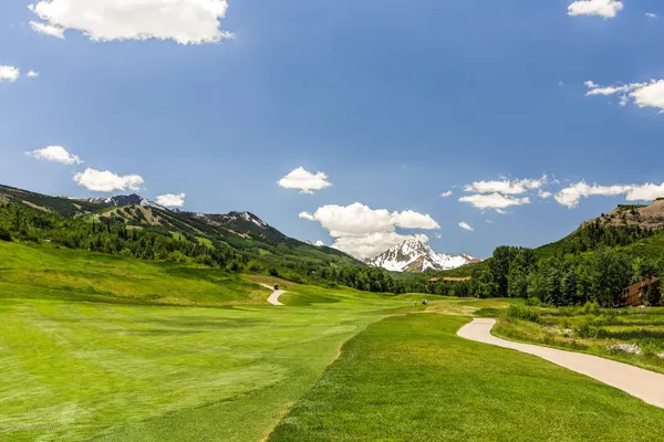 a view of a golf course with a lake