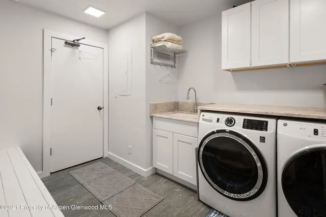 a view of a storage and utility room with washer and dryer