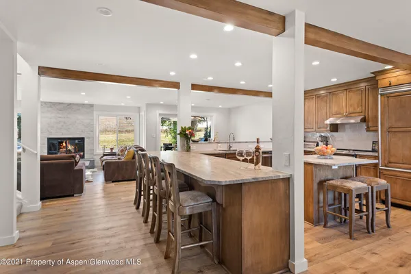 a kitchen with stainless steel appliances kitchen island granite countertop a table and chairs