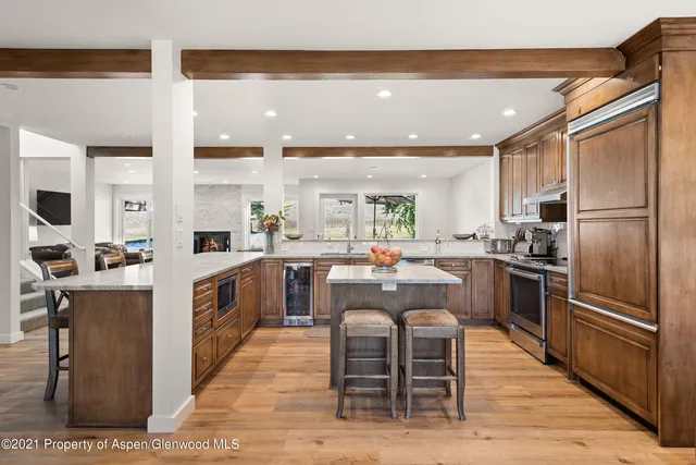 a kitchen with refrigerator cabinets and wooden floor