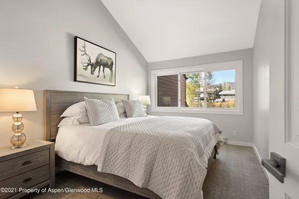a bedroom with bed and painting on the wall