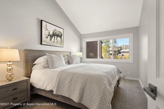 a bedroom with bed and painting on the wall